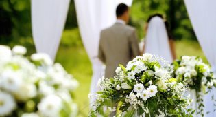 White flowers decorations during outdoor wedding ceremony
